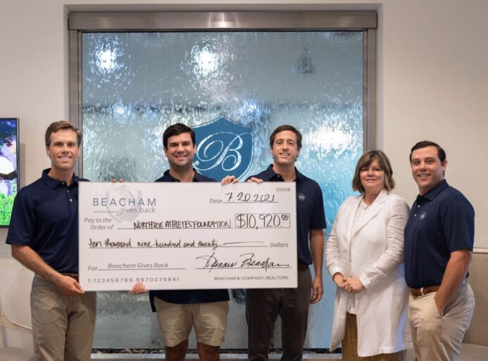 Beacham and Company, Realtors broker Nancy Meister presents a check to the Northside Athletes Foundation. From left to right: Bobby Jackson, Charlie Caswell, Dixon Raney, Nancy Meister and Wills Aitkens